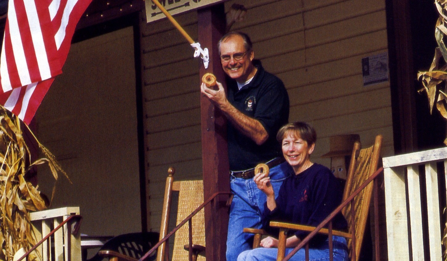 John and Mimi holding a donut at the Mill